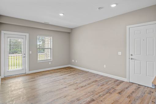 A room with wooden floors and white walls.