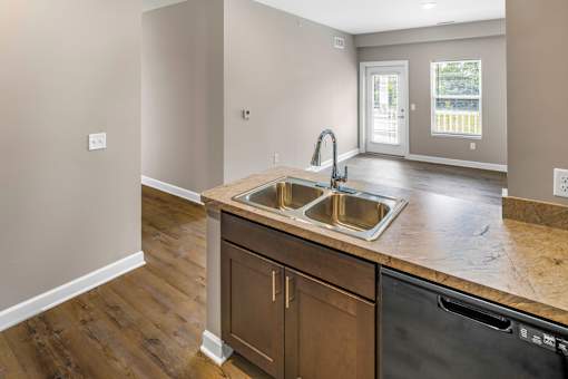 A kitchen with a sink and a dishwasher.
