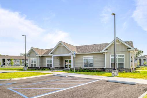 A large building with a parking lot in front of it.