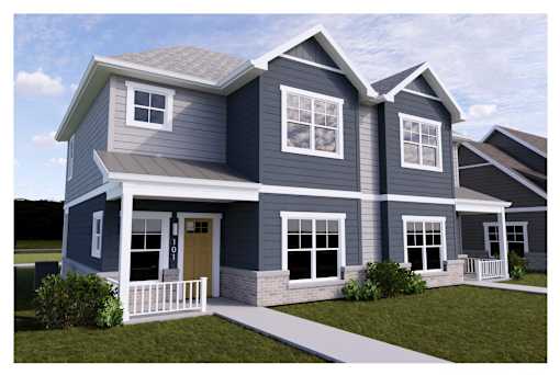 A modern two-story house with a front porch and a white picket fence.
