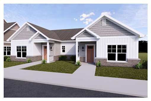 A modern house with a brown door and a grey roof.