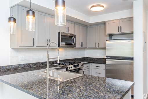 A kitchen with granite countertops and stainless steel appliances.