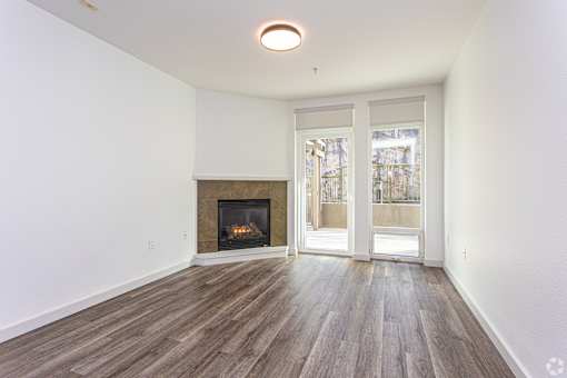 A room with a fireplace and a door leading to another room.