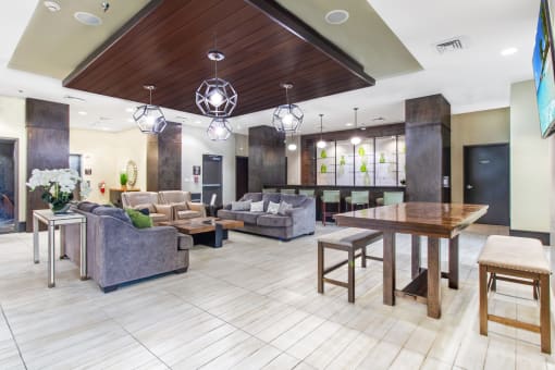 a lobby with couches chairs and a table at One Plantation in Plantation, Florida 33324