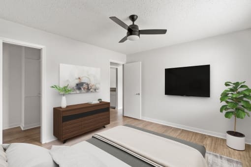 a living room with a ceiling fan and a bed