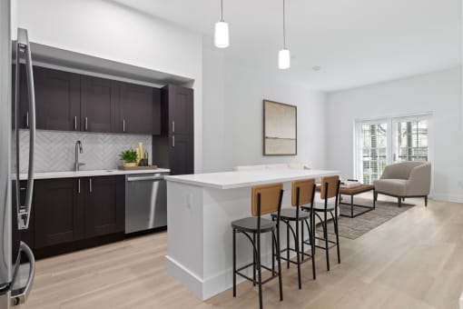 an open kitchen and living room with a white counter top at One Plantation in Florida 33324