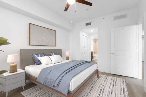 a bedroom with a large bed and a ceiling fan at One Plantation in Florida 33324