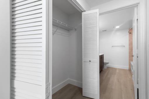 a small bathroom with a white closet and a toilet at One Plantation in Plantation, Florida 33324