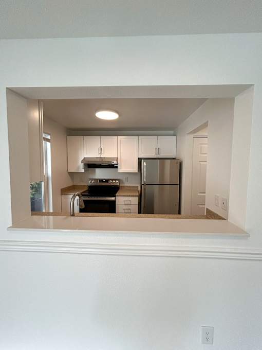 A kitchen with white cabinets and appliances at 2000 Lake Washington Apartments, Renton, WA