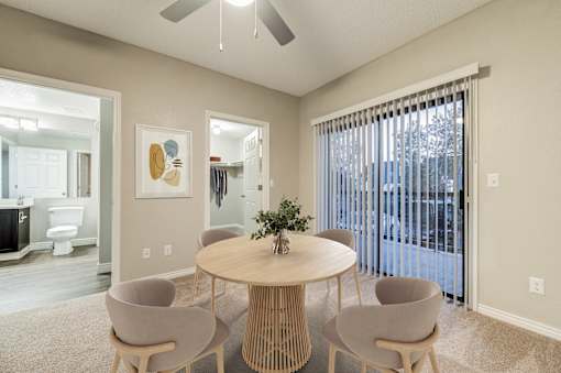 A dining room with a round table and four chairs at Ashford Belmar in Lakewood, 80226