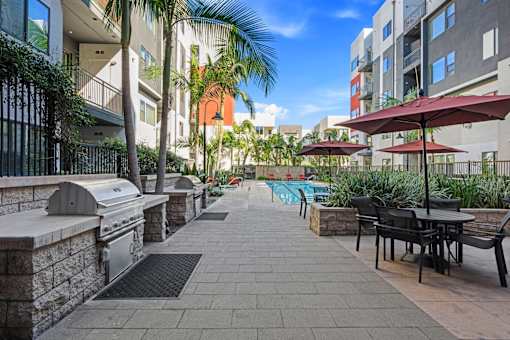 A patio with a table and chairs is surrounded by buildings.