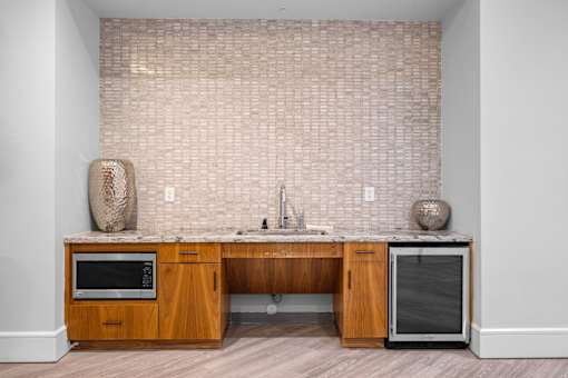 A kitchen with a wooden island and a microwave.