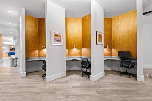 A room with a gold wallpaper and a white column.