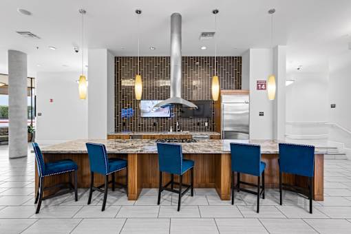 A kitchen area with a table and chairs.