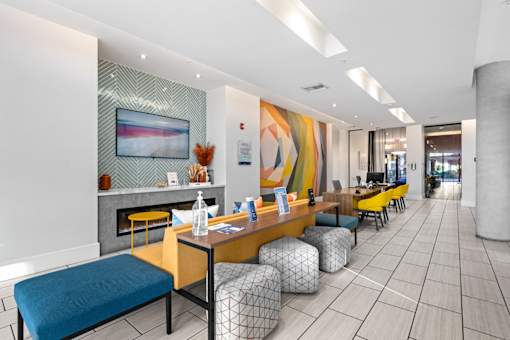 A modern waiting room with a fireplace and comfortable seating.