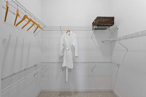 A white bathroom with a towel hanging on a rack.
