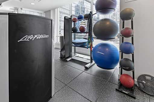 A gym with a Life Fitness refrigerator and a variety of exercise equipment.