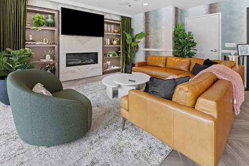 A modern living room with a fireplace and a green armchair.