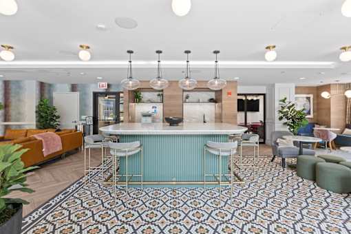 A modern kitchen with a bar area and a patterned floor.