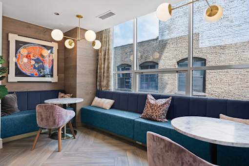 A modern dining area with a blue bench and a round table.