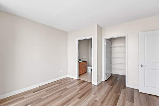 A room with a white door and a white wall.
