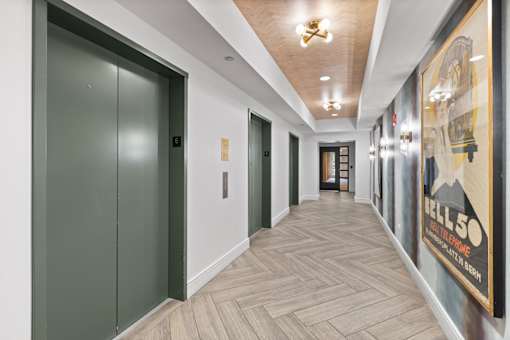 A long hallway with a poster on the wall.
