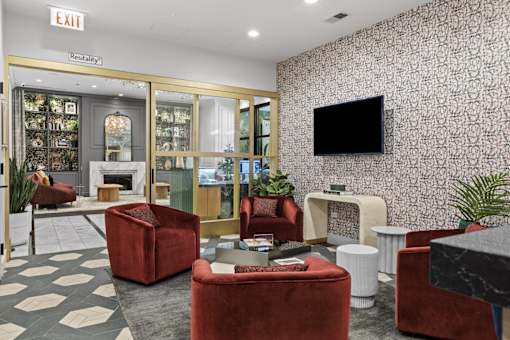A living room with a fireplace and a television on the wall.
