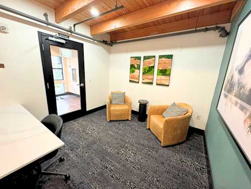 A room with a white table, two chairs and a carpet at The Lakes in Washington 98007