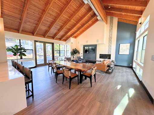 A dining room with a wooden table and chairs at The Lakes in Bellevue, Washington 98007