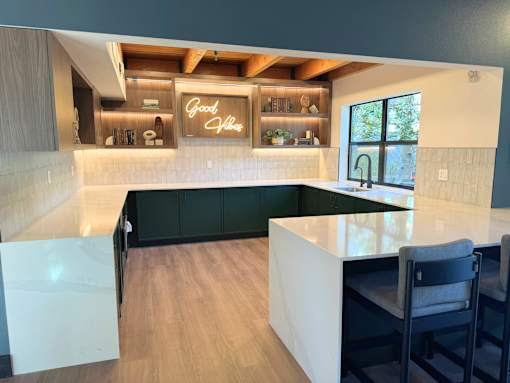 A kitchen with a white countertop and a neon sign that says Good Vibes at The Lakes in WA 98007