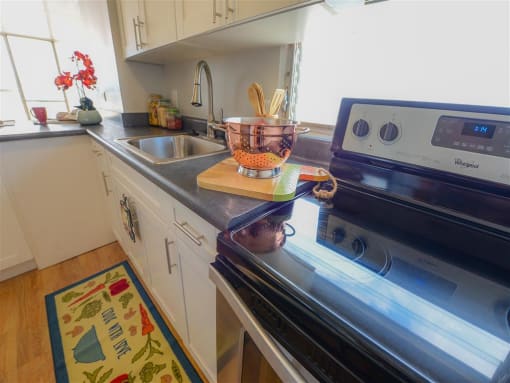 kitchen with stainless steel appliances and white cabinets at Waikele Towers, Waipahu, HI, 96797