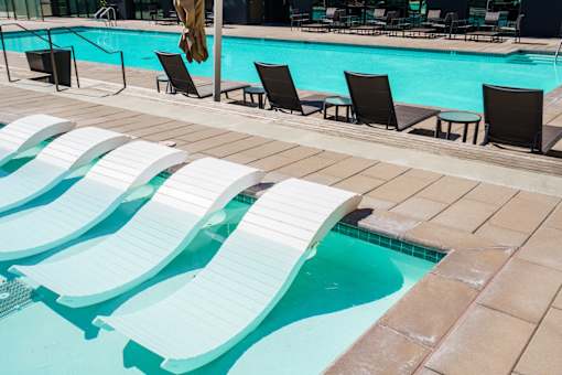 Pool with white sun loungers at Misora Apartments, San Jose, CA