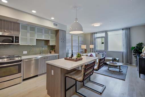 a kitchen and living room with a table and chairs at L Seven, CA 94103