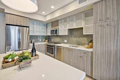 a kitchen with stainless steel appliances and white counter tops at L Seven, San Francisco, California 94103