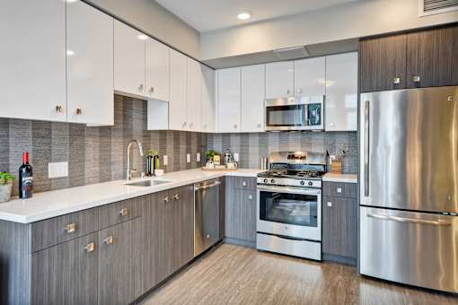 a kitchen with stainless steel appliances and white cabinets at L Seven, California, 94103