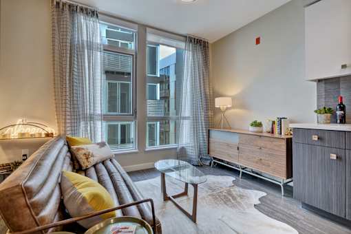 a living room with a couch and a large window at L Seven, San Francisco