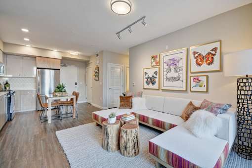a living room with a white couch and a kitchen with a table at L Seven, California, 94103