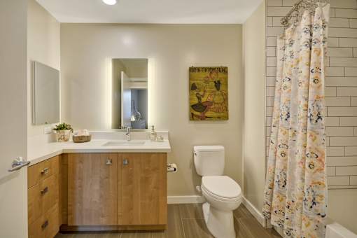 a bathroom with a toilet and a sink and a shower curtain at L Seven, San Francisco, CA