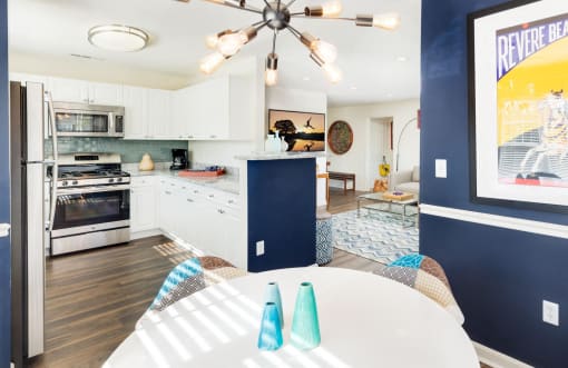 a kitchen and dining room with a table and a ceiling fan at Residences at Stevens Pond, Saugus, Massachusetts 01906