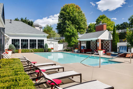 a swimming pool with lounge chairs next to a resort style pool at Residences at Stevens Pond, Massachusetts
