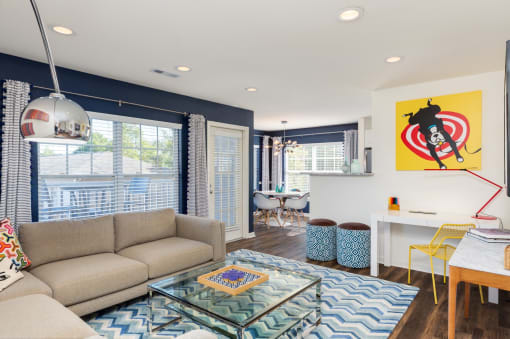 a living room with a couch and a glass coffee table at Residences at Stevens Pond, MA 01906