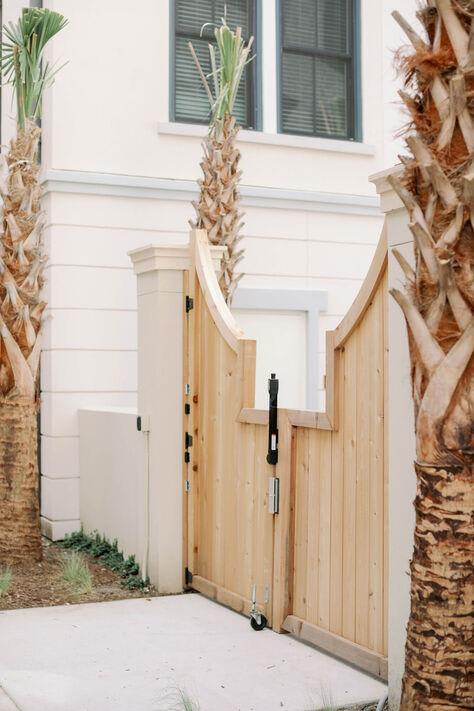Coastal style-wooden fence with surrounding palm trees at The Merchant Apartments, South Carolina 29403