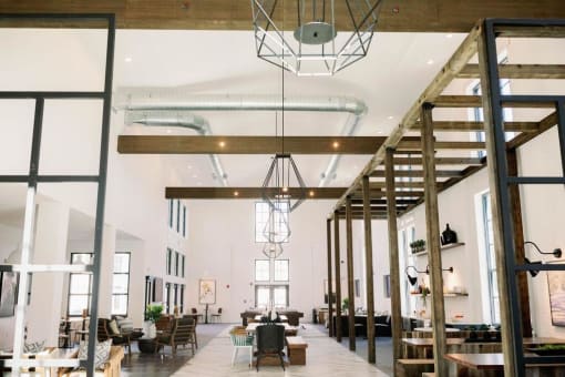 Market-style resident lounge with comfortable seating and wood beaming along the ceilings at The Merchant Apartments, South Carolina