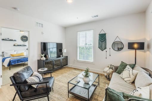 living room with a couch and a tv at The Merchant Apartments, Charleston, SC, 29403