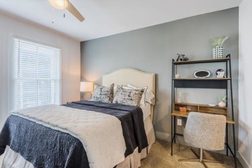 a bedroom with a bed and a nightstand at The Merchant Apartments, South Carolina