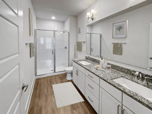 a bathroom with two sinks and a shower at The Merchant Apartments, Charleston, South Carolina