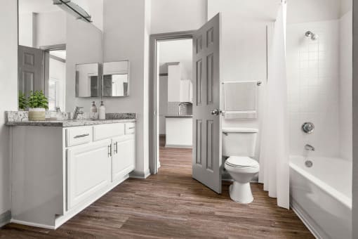 a white bathroom with a toilet and a sink at Aston at Cinco Ranch, Katy, 77450