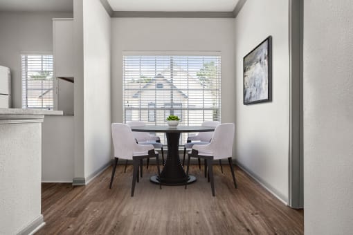 a dining room with a table and chairs and a window at Aston at Cinco Ranch, Katy, Texas