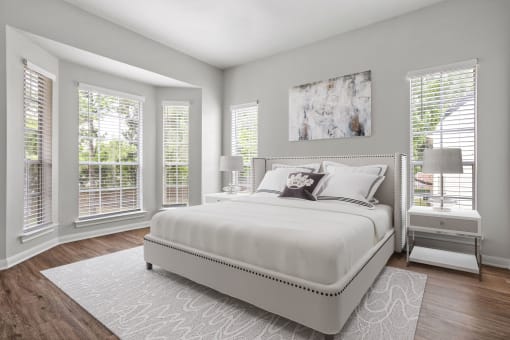 a bedroom with a large bed and windows at Aston at Cinco Ranch, Katy, Texas