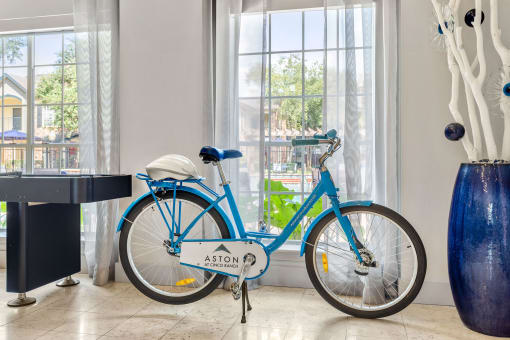 a blue bike parked in front of a window at Aston at Cinco Ranch, Katy